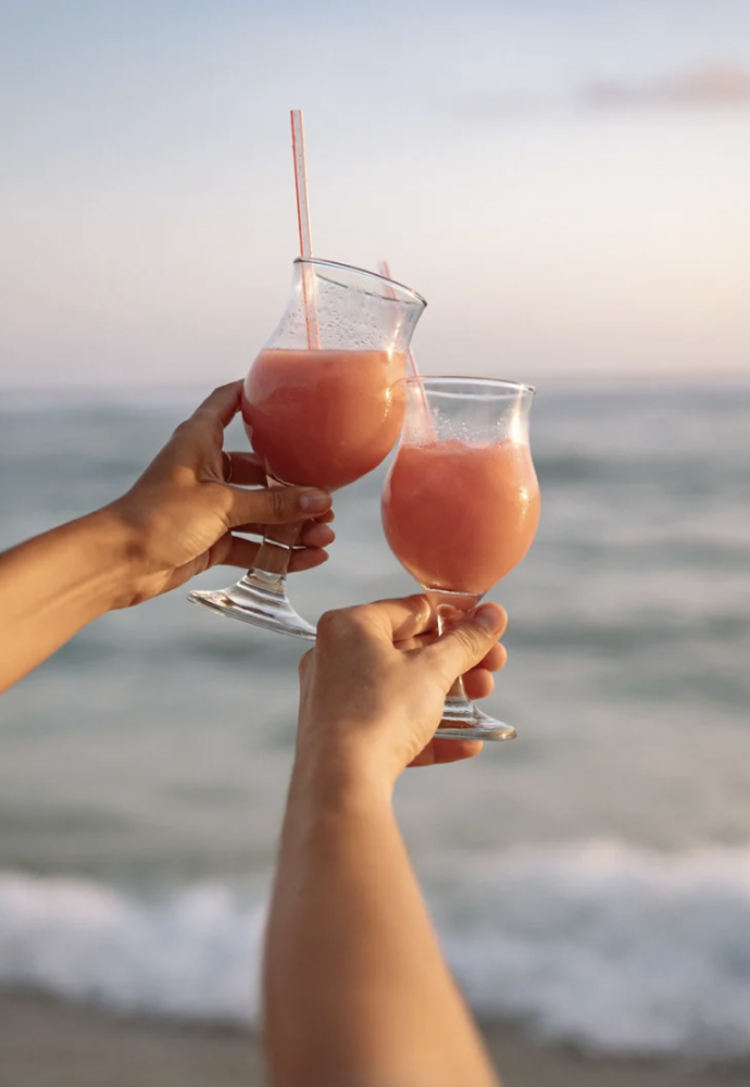A tropical-inspired dairy-free cocktail with OATRAGEOUS Coconut liqueur, citrus, and Aperol.
